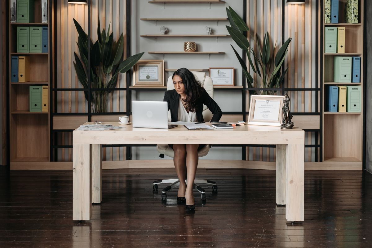 Professional woman working on laptop in modern office
