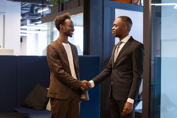 diaspora-tax-filing-2026-v3 Two African businessmen shaking hands in office