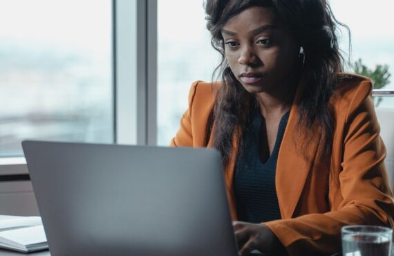 African businesswoman working on tax filing on her laptop