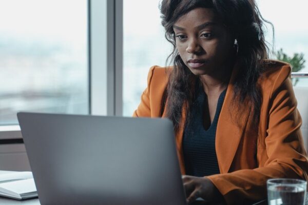 kra-tax-filing-kenya-2026-v3 African businesswoman working on tax filing on her laptop