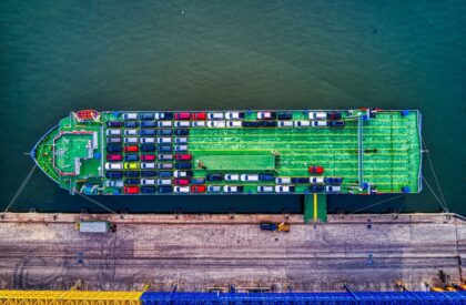 ship-car-usa-kenya-2026-v3 Aerial view of a car carrier ship loaded with vehicles